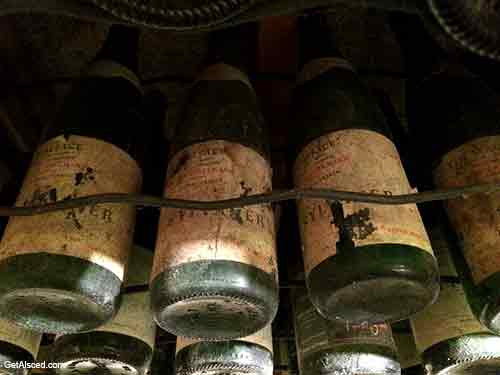 old white wine bottles aging in a wine cellar in alsace france